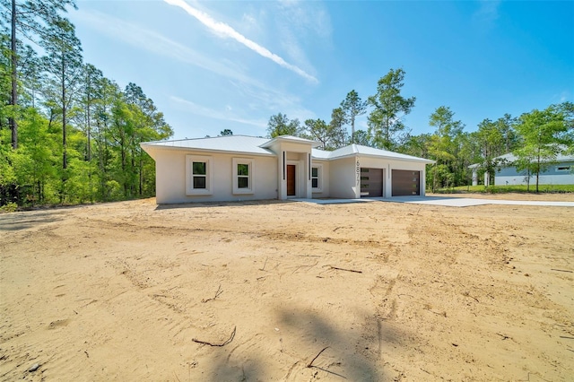 6877 SW 131st Cir, Ocala, FL 34481 - view of front of house with a garage, stucco siding, and driveway
