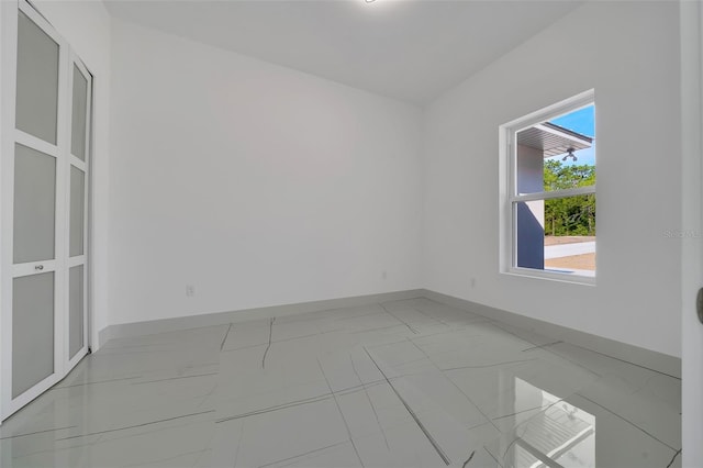 6877 SW 131st Cir, Ocala, FL 34481 - empty room with light marble finish floors and baseboards