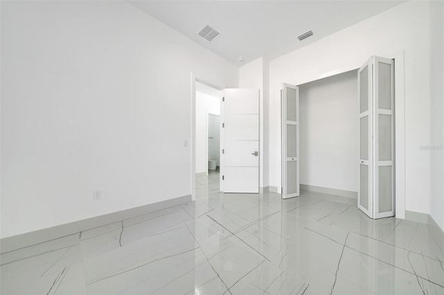 6877 SW 131st Cir, Ocala, FL 34481 - unfurnished bedroom featuring light marble finish flooring and baseboards