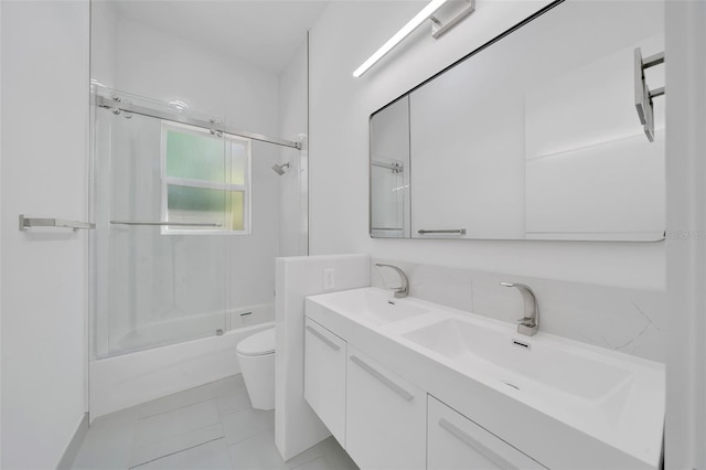 6877 SW 131st Cir, Ocala, FL 34481 - bathroom featuring toilet, shower / bath combination with glass door, and double vanity