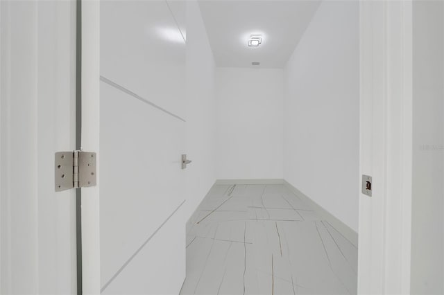 6877 SW 131st Cir, Ocala, FL 34481 - laundry area with light marble finish flooring and baseboards