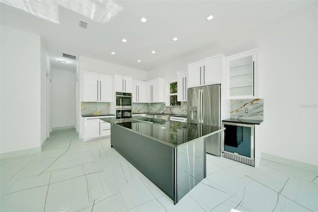6877 SW 131st Cir, Ocala, FL 34481 - kitchen with stainless steel appliances, light marble finish floors, a center island, baseboards, and recessed lighting