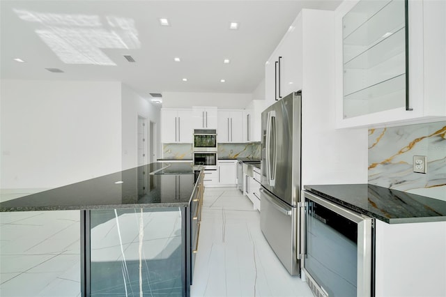 6877 SW 131st Cir, Ocala, FL 34481 - kitchen with stainless steel appliances, wine cooler, decorative backsplash, white cabinetry, and a kitchen island