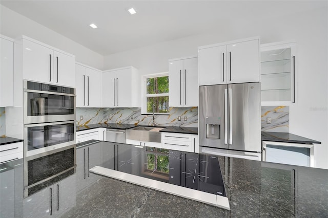 6877 SW 131st Cir, Ocala, FL 34481 - kitchen featuring appliances with stainless steel finishes, a sink, tasteful backsplash, and white cabinetry
