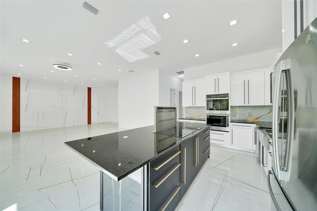 6877 SW 131st Cir, Ocala, FL 34481 - kitchen with stainless steel appliances, white cabinets, backsplash, modern cabinets, and light marble finish flooring
