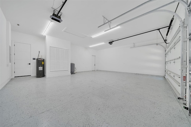 6877 SW 131st Cir, Ocala, FL 34481 - garage featuring electric water heater and a garage door opener