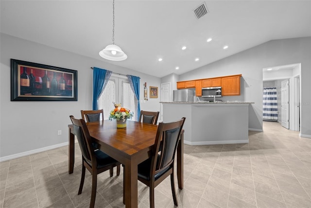 tiled dining area with lofted ceiling