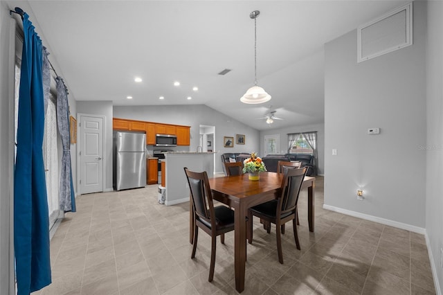 tiled dining area with vaulted ceiling and ceiling fan