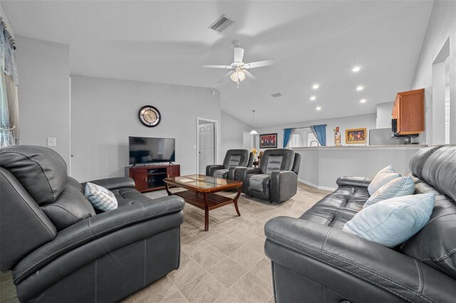 living room with ceiling fan and vaulted ceiling