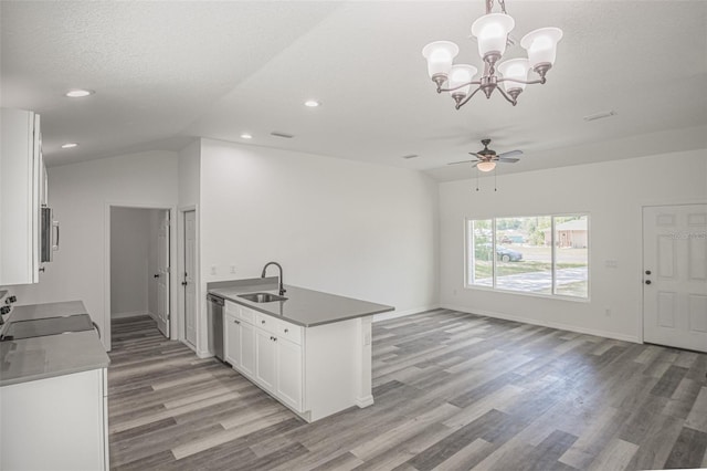 kitchen featuring appliances with stainless steel finishes, pendant lighting, ceiling fan with notable chandelier, white cabinets, and sink