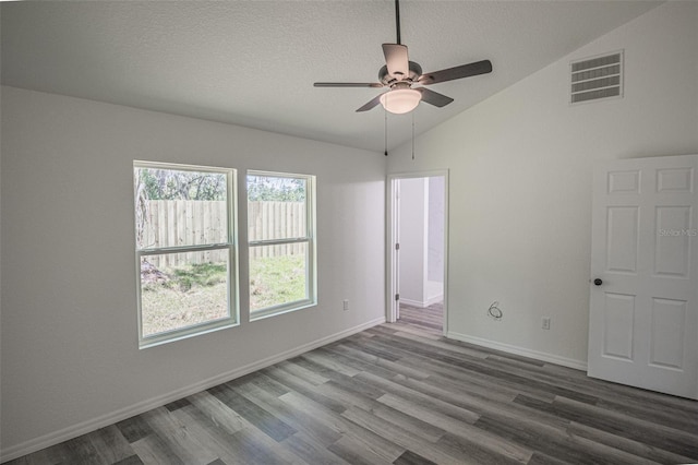 spare room with ceiling fan, vaulted ceiling, and hardwood / wood-style flooring