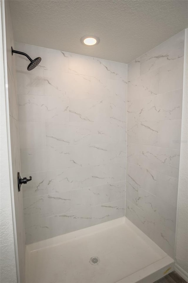 bathroom with a tile shower