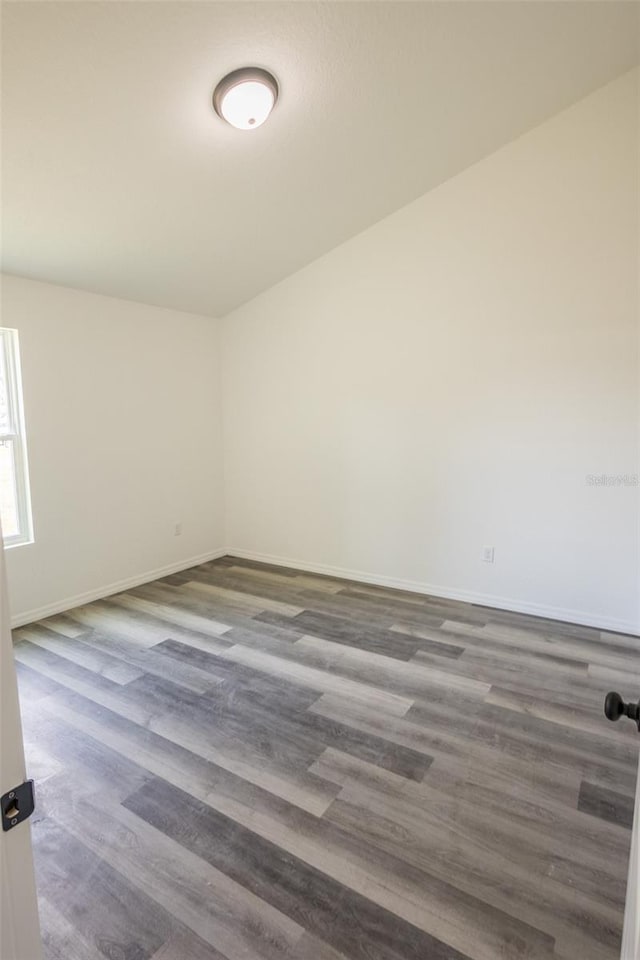 empty room with dark hardwood / wood-style flooring