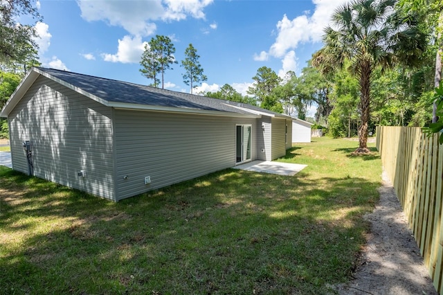 view of side of property with a yard