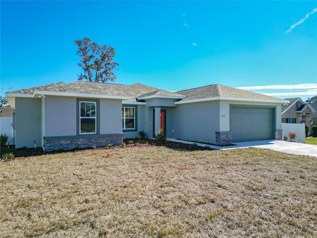 ranch-style home featuring a garage and a front lawn