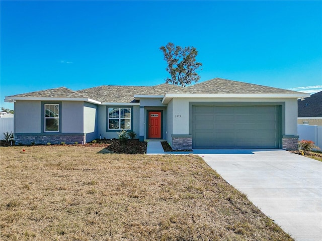 ranch-style house featuring a garage and a front lawn