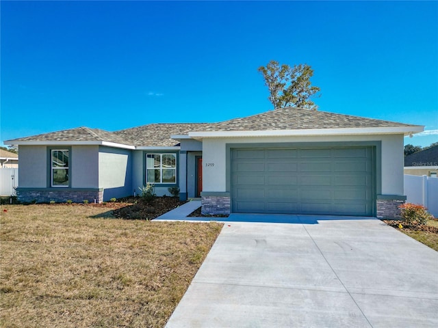 ranch-style house featuring a garage and a front yard