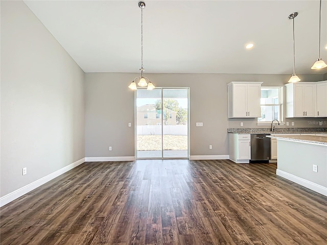 kitchen featuring white cabinetry, pendant lighting, stainless steel dishwasher, and dark hardwood / wood-style floors