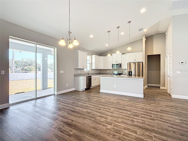 kitchen featuring sink, a center island, hanging light fixtures, appliances with stainless steel finishes, and white cabinets