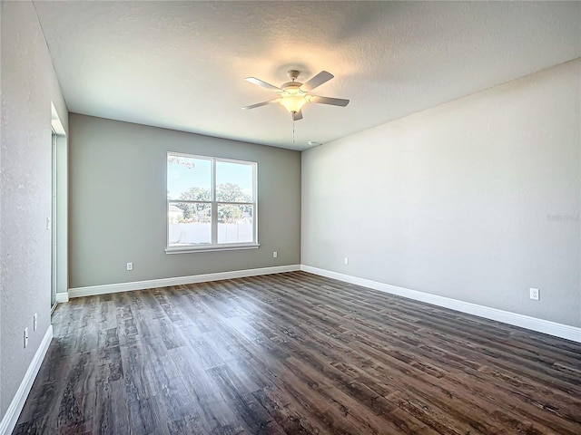 spare room with a textured ceiling, dark hardwood / wood-style floors, and ceiling fan