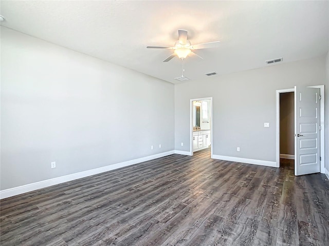 unfurnished bedroom with dark wood-type flooring, ceiling fan, and ensuite bathroom