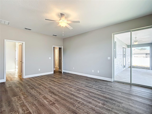 empty room featuring dark wood-type flooring and ceiling fan