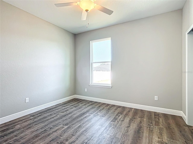 spare room featuring dark wood-type flooring and ceiling fan