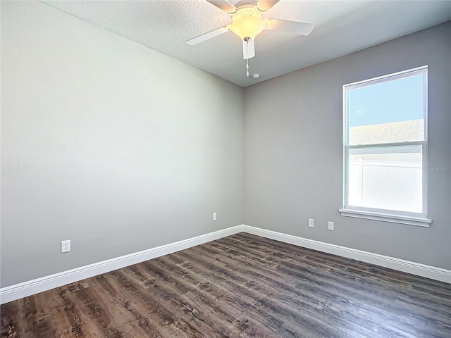 spare room featuring dark hardwood / wood-style flooring, a textured ceiling, and ceiling fan