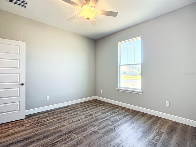 empty room featuring dark wood-type flooring and ceiling fan