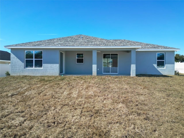 back of house with a lawn