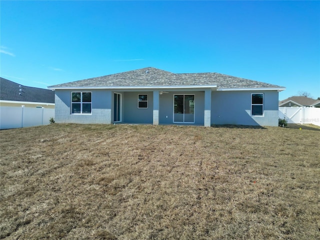 back of house with a lawn