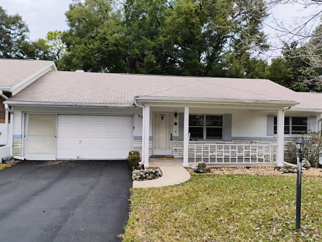 single story home with a garage, a front yard, and a porch