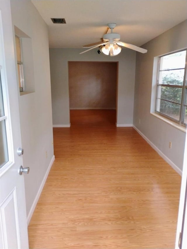 spare room featuring ceiling fan and light hardwood / wood-style floors