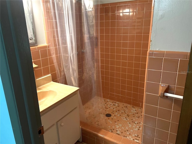 bathroom with vanity, tile walls, and a shower with shower curtain