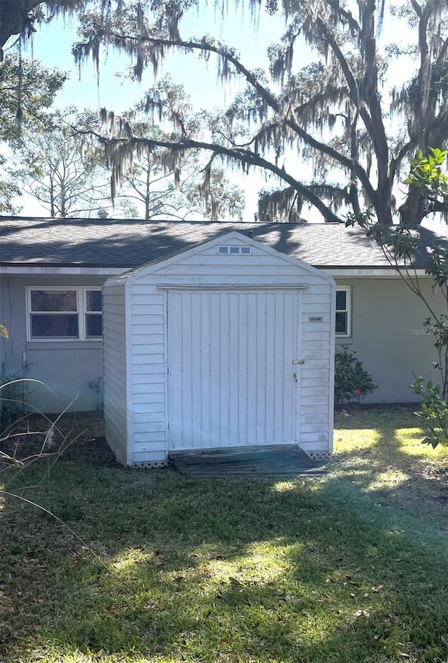 view of outbuilding with a yard