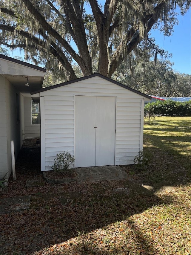 view of outdoor structure with a lawn