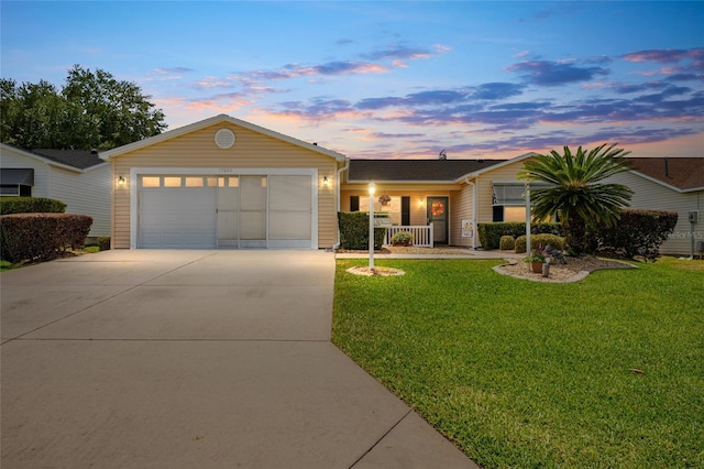 single story home with a garage and a yard