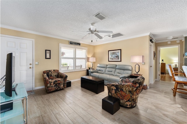 living room featuring crown molding and light hardwood / wood-style flooring