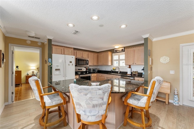 kitchen featuring a center island, stainless steel appliances, decorative backsplash, sink, and crown molding