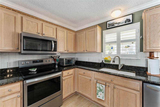 kitchen with backsplash, dark stone countertops, sink, stainless steel appliances, and a textured ceiling