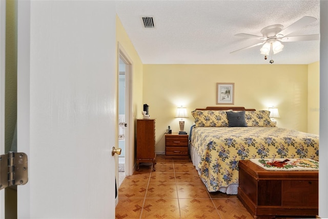 tiled bedroom featuring ceiling fan and a textured ceiling