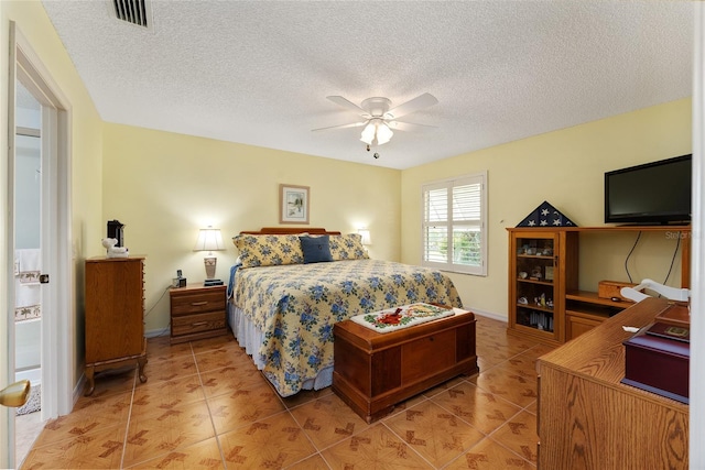 tiled bedroom with a textured ceiling and ceiling fan