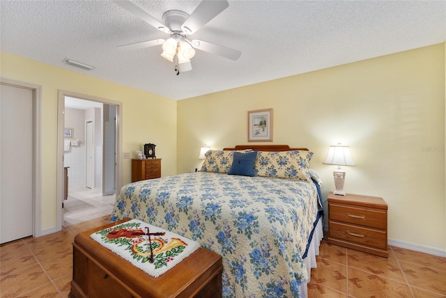 tiled bedroom featuring ceiling fan and a textured ceiling