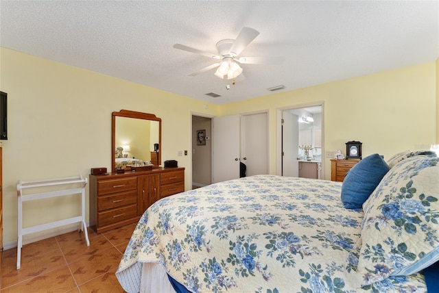 bedroom featuring a textured ceiling, ceiling fan, and light tile patterned floors