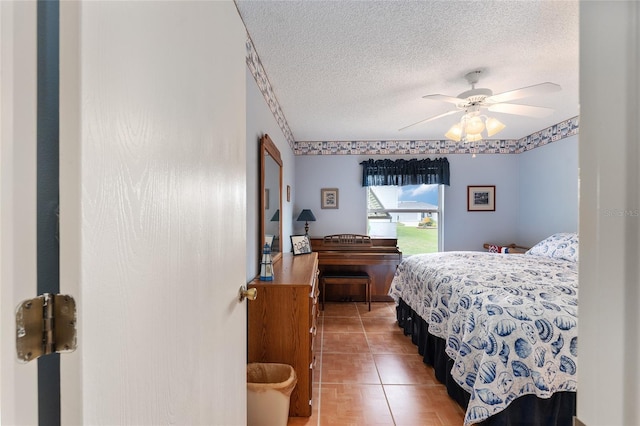 bedroom with a textured ceiling and ceiling fan