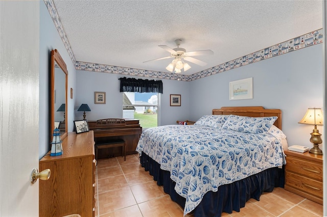 bedroom with ceiling fan, a textured ceiling, and light tile patterned floors