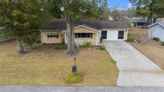 single story home with covered porch, a front lawn, and a garage