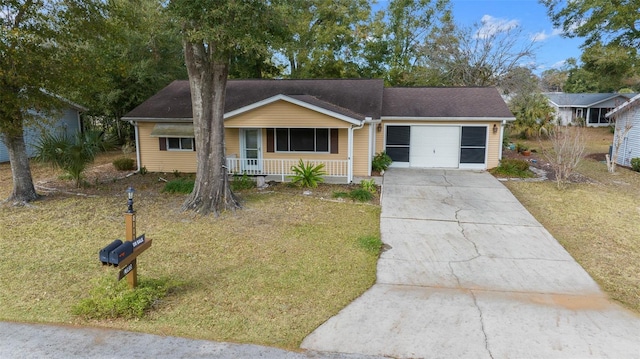 ranch-style house with covered porch, a garage, and a front lawn