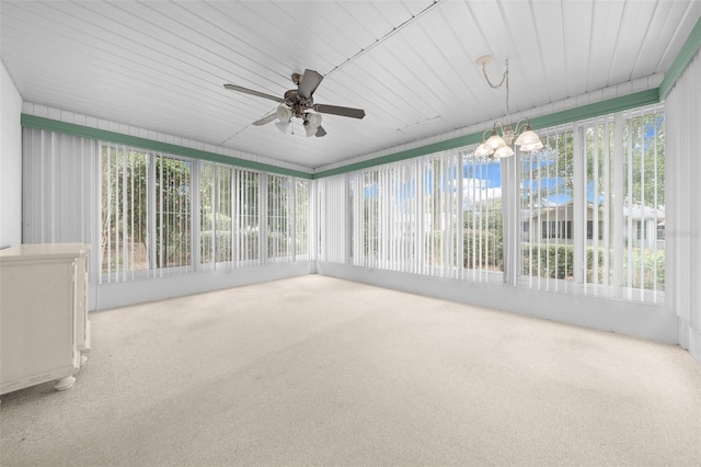 unfurnished sunroom featuring ceiling fan with notable chandelier