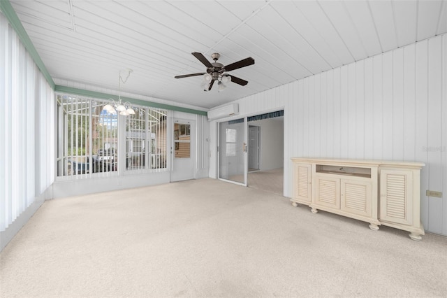 interior space featuring ceiling fan with notable chandelier and a wall mounted air conditioner